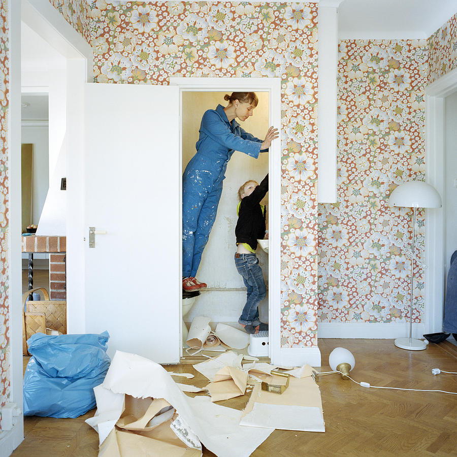 Mother and son renovating bathroom Photograph by Johner Images