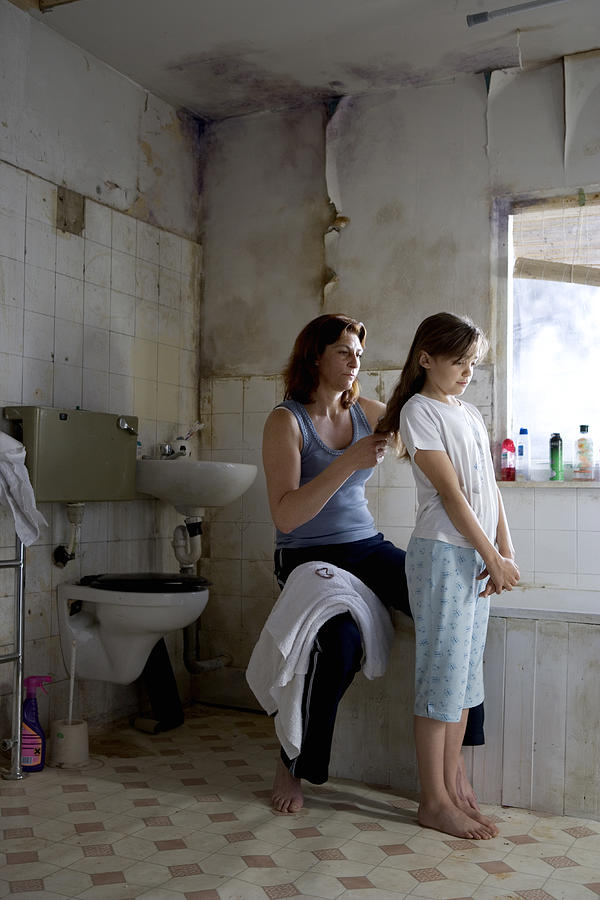 Mother brushing girls hair in bathroom Photograph by Jw Ltd