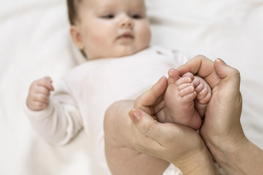 Mother holding childs feet Photograph by Vladimir Godnik