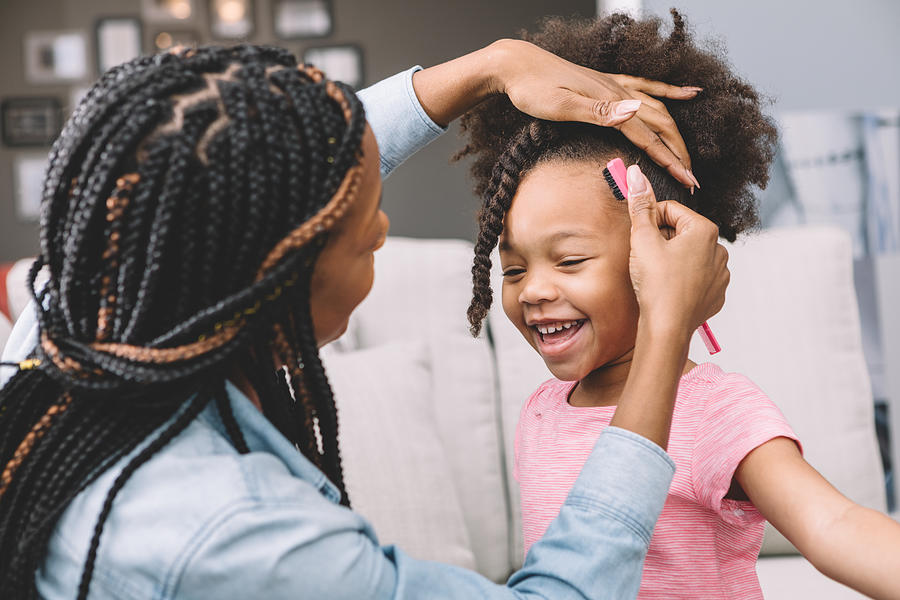Mother Styling Daughters Curly Hair Photograph by Marilyn Nieves