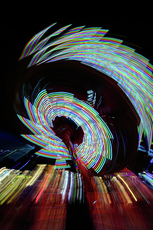 Motion blur of amusement ride lights Photograph by David Ilzhoefer