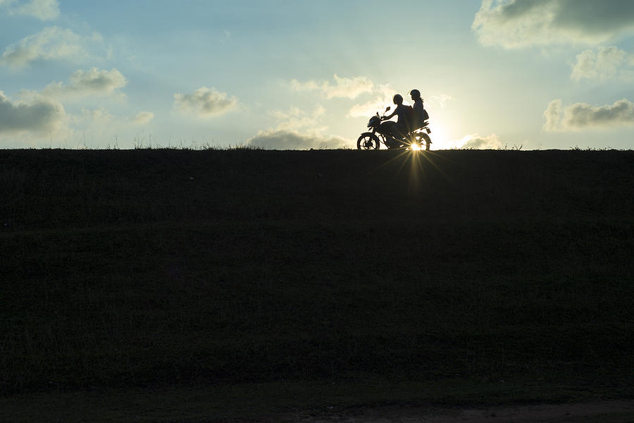 Motorcycle couple silhouetted at sunset Photograph by Brett Davies - Photosightfaces