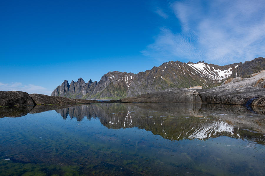 Mountain Oksehornet, Djevelens tanngard reflecting in the water at Tungeneset at the island of Senja in Northern Norway Photograph by Finn Bjurvoll Hansen