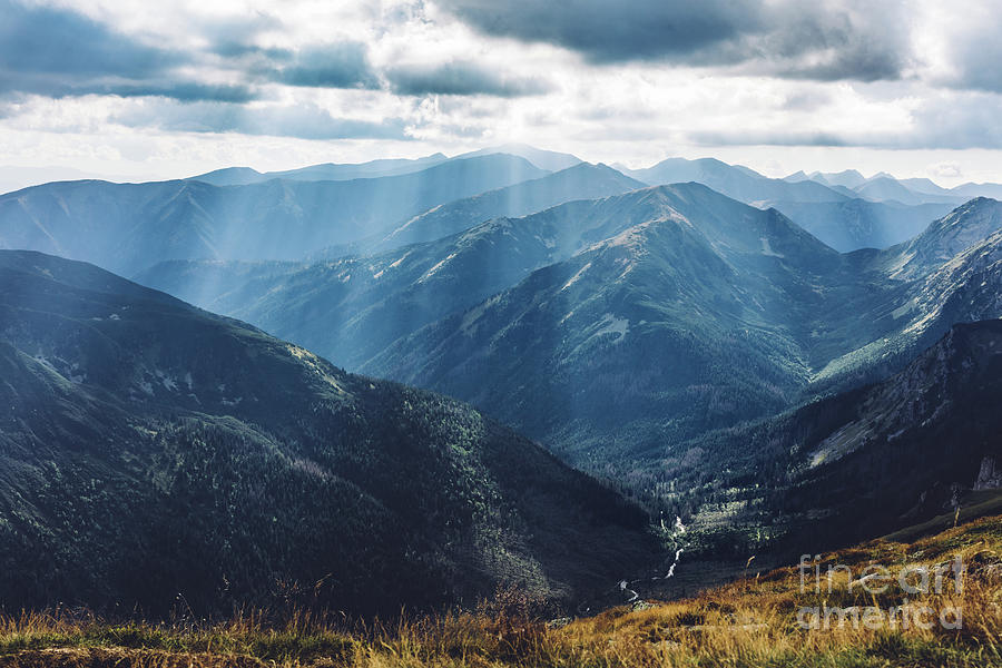 Mountain peaks in sunbeams. Tatra Mountains in Poland. Photograph by Michal Bednarek