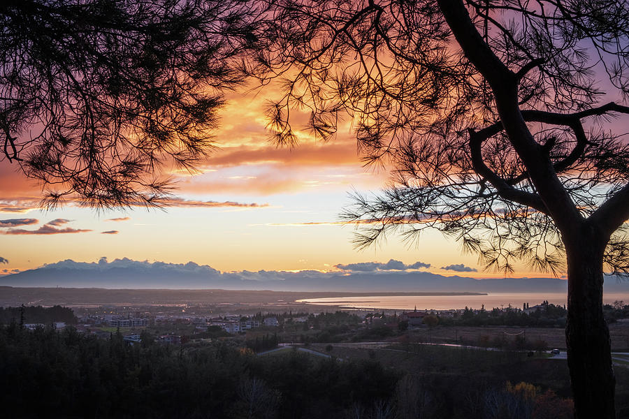 Mountain Range Framed by Tree Branches at Sunset Photograph by Alexios Ntounas