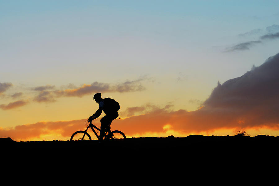 Mountain rider biker on sunset  landscape Photograph by Severija Kirilovaite