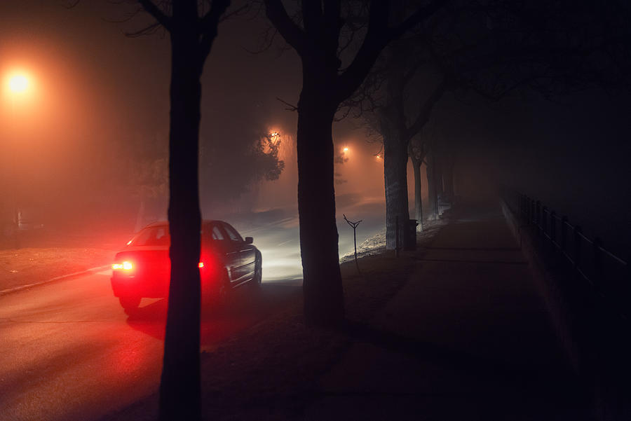 Moving car and walkway on misty night Photograph by Slavica