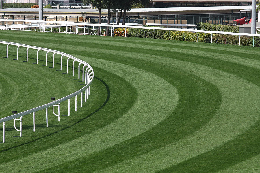 Mowed lawn used as a horse racing track restricted by fence Photograph by Winhorse