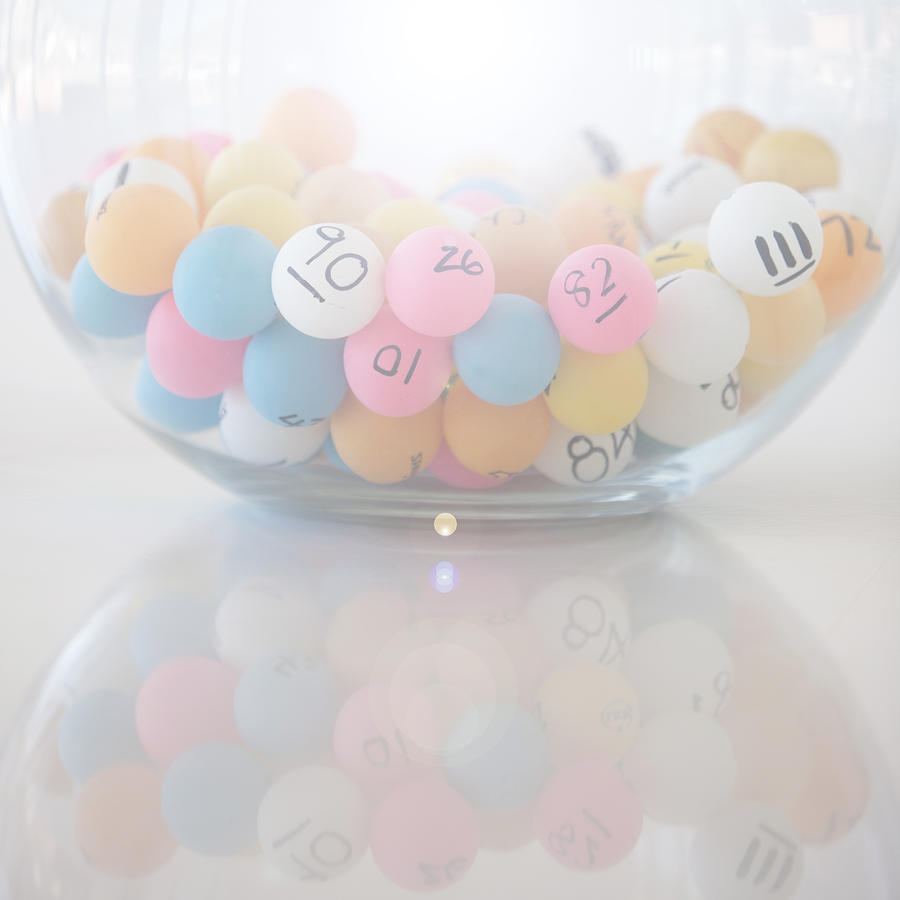 Multi-colored Lottery balls in glass bowl Photograph by Russellglenister