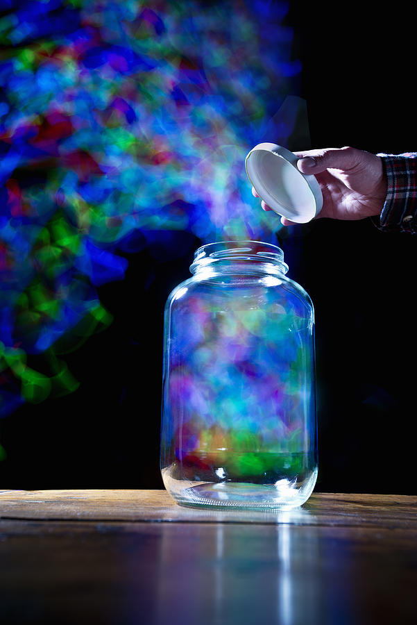 Multi colored vapor escaping jar Photograph by PM Images
