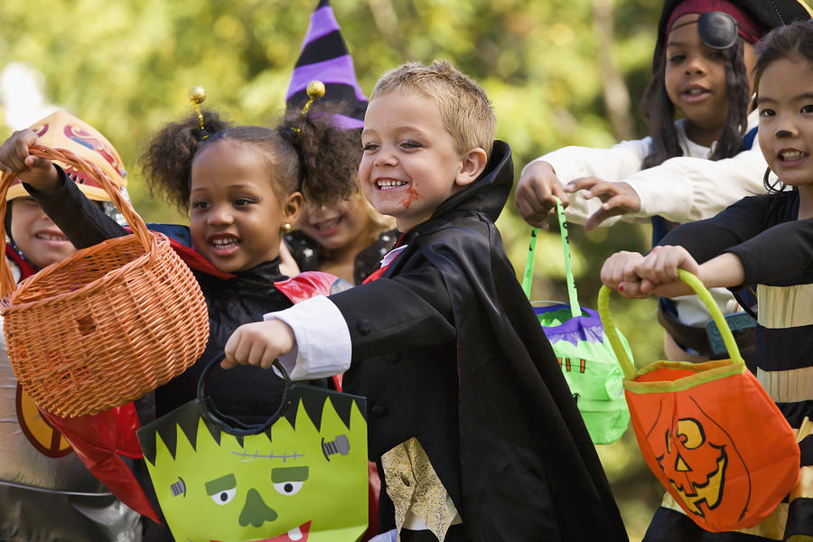Multi-ethnic children dressed in Halloween costumes Photograph by Ariel Skelley