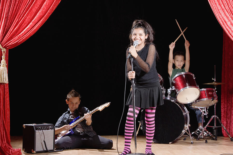Multi-ethnic children performing in band Photograph by Terry Vine