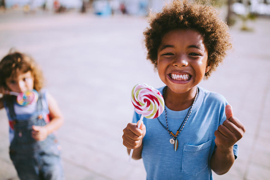 Multi-ethnic children with colorful lollipops outdoors on summer vacations Photograph by Wundervisuals