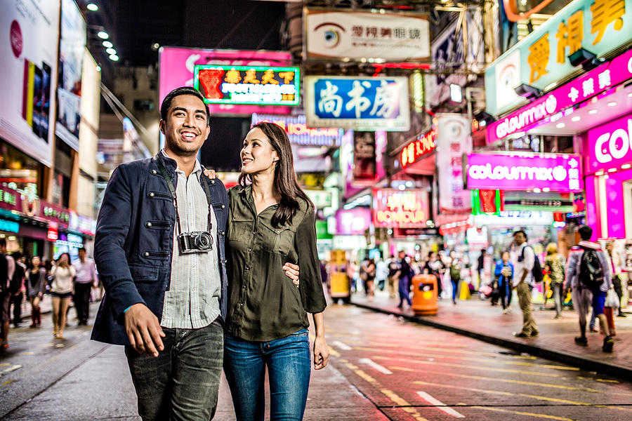 Multi-ethnic couple in Hong Kong walking street Photograph by Itsskin