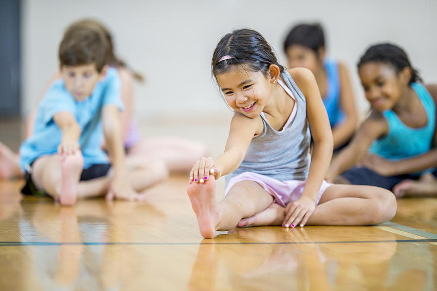 Multi-ethnic elementary age group stretching Photograph by FatCamera