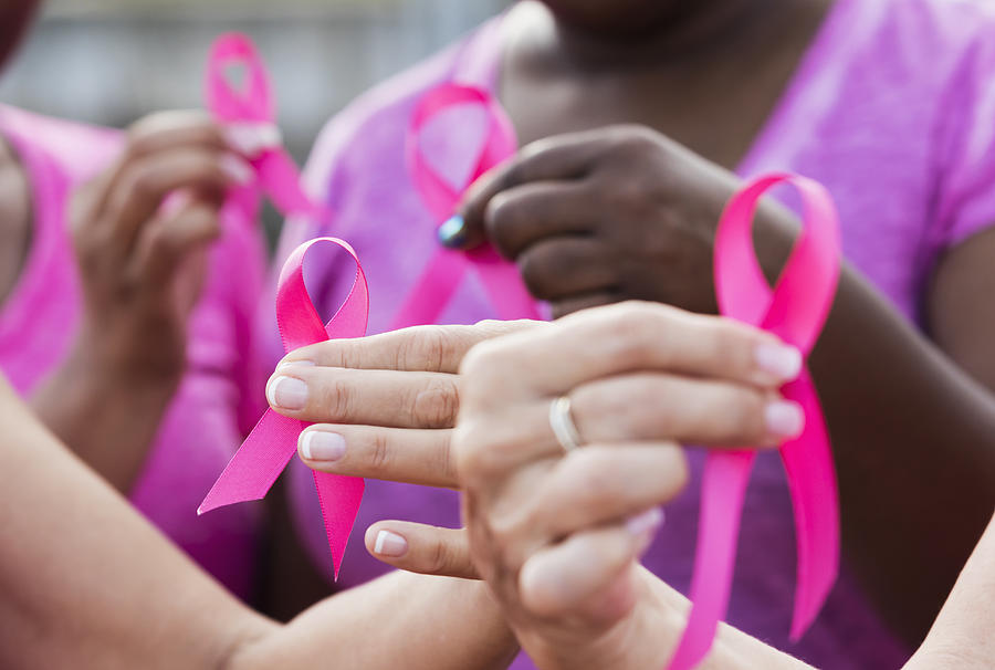 Multi-ethnic women with breast cancer awareness ribbons Photograph by Kali9