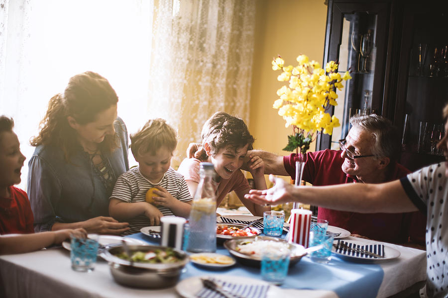 Multi generation family dinner Photograph by MilosStankovic