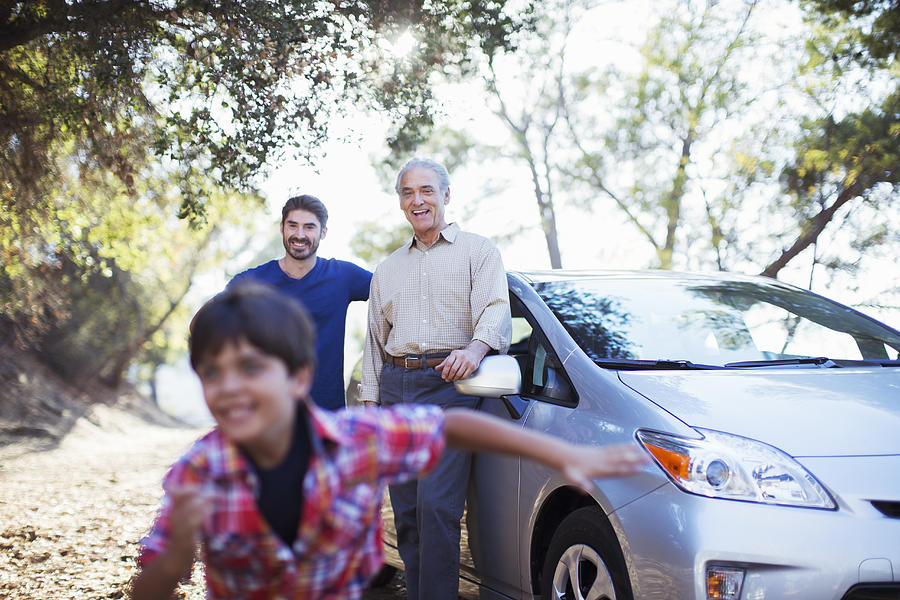 Multi-generation men outside car Photograph by Caia Image