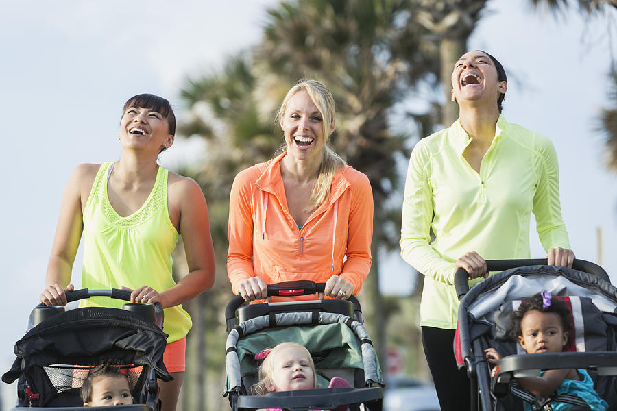 Multi-racial mothers with babies in jogging strollers Photograph by Kali9