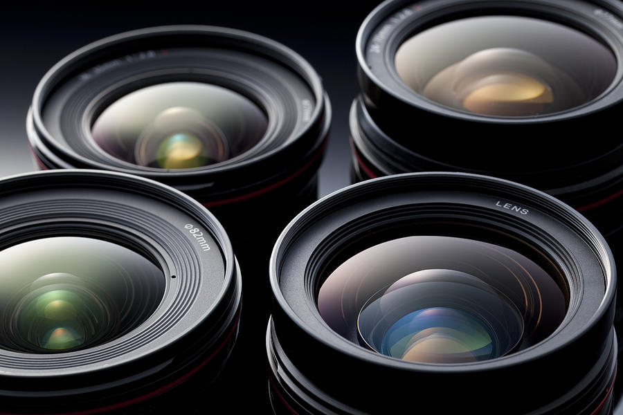 Multiple camera lenses, reflective lenses Photograph by Studiocasper
