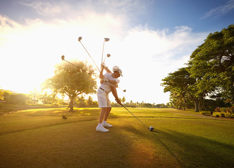 Multiple exposures of Caucasian golfer hitting ball on course Photograph by Colin Anderson Productions pty ltd
