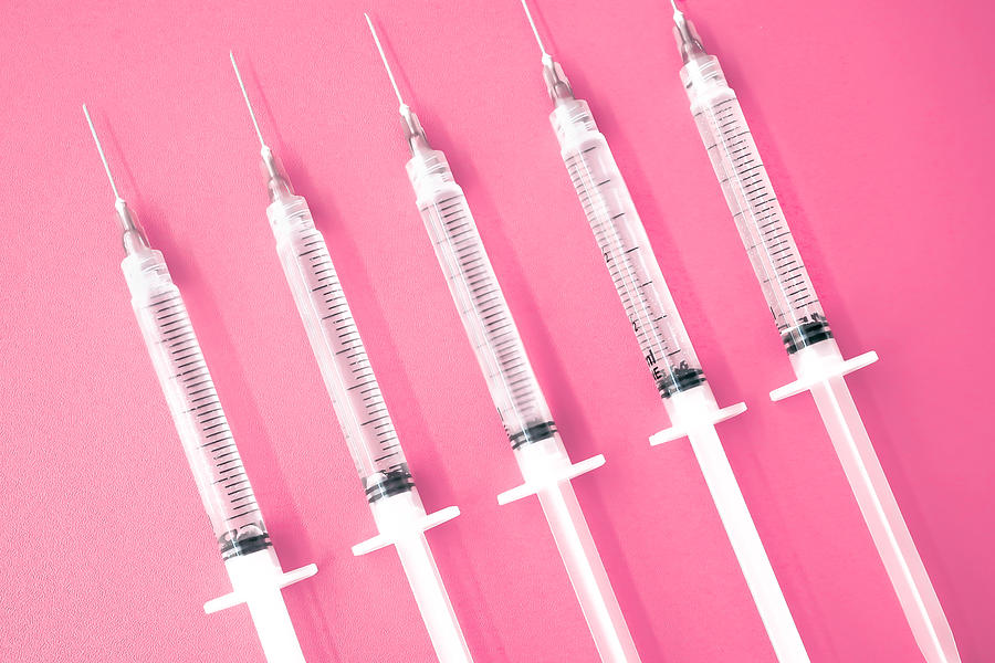 Multiple Syringes With Needles on Pink Background Photograph by Grace Cary