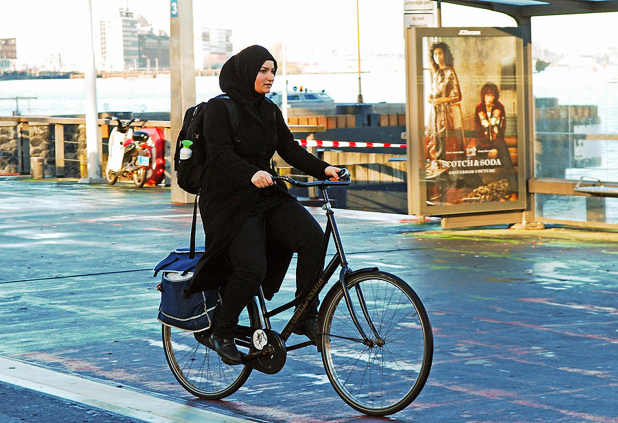 Muslim Woman riding a bicycle. Photograph by MaestroBooks