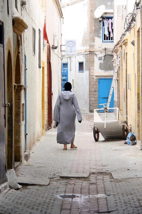 Muslim woman walking in narrow street Photograph by David Oliete