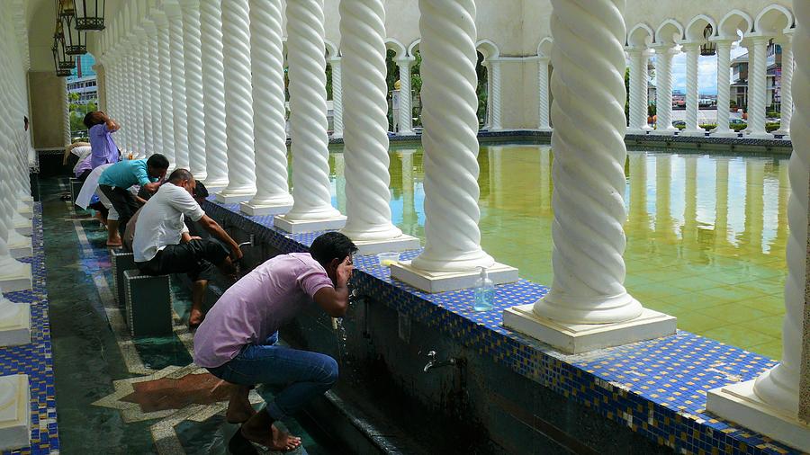 Muslims washing before praying Photograph by Robert Bociaga