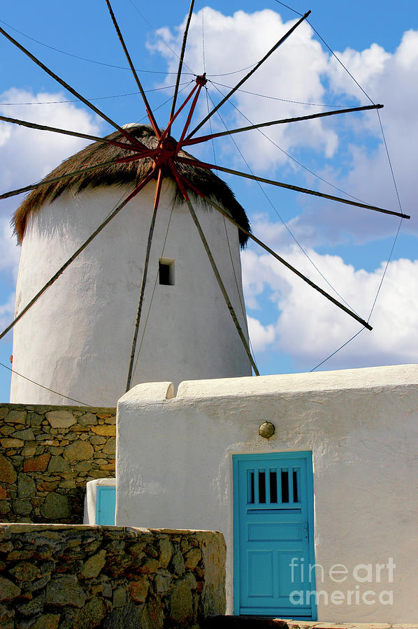 Mykonos windmill with a cloudy blue and white sky. Photograph by Gunther Allen