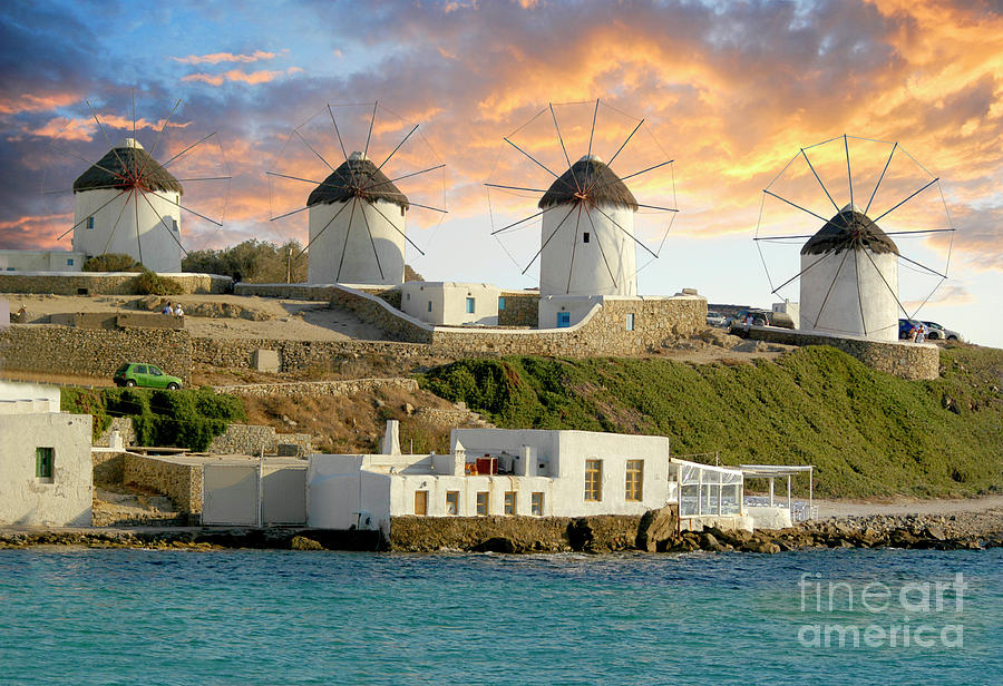 Mykonos windmills in a row as the spectacular sunset lights them up.  Photograph by Gunther Allen