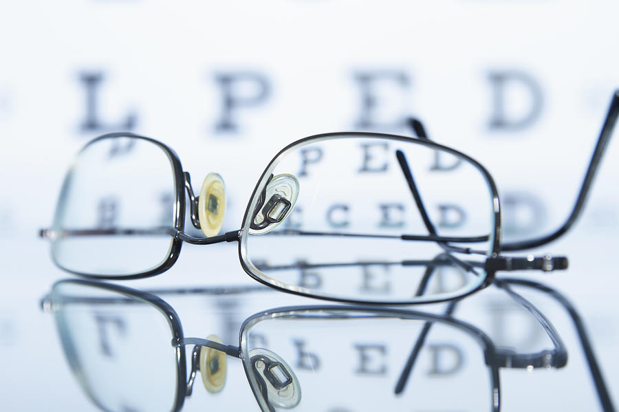 Myopic spectacles with a Snellen eye chart in the background Photograph by GIPhotoStock