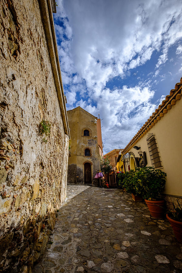 Narrow alley and old houses with plants outside in Castelmola Taormina Sicily Italy Photograph by Finn Bjurvoll Hansen
