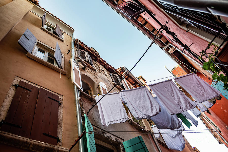 Narrow Alley With Old Houses And Freshly Washed Laundry In The City Of Rovinj In Croatia Photograph by Andreas Berthold