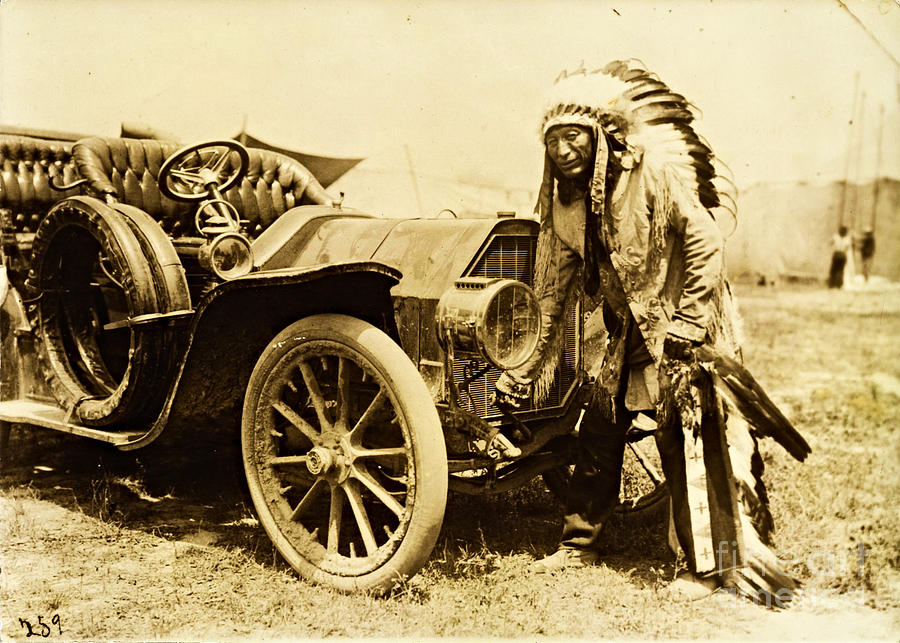 Native American Indian with Feathered Headdress and early automobile circa 1905 Photograph by Peter Ogden