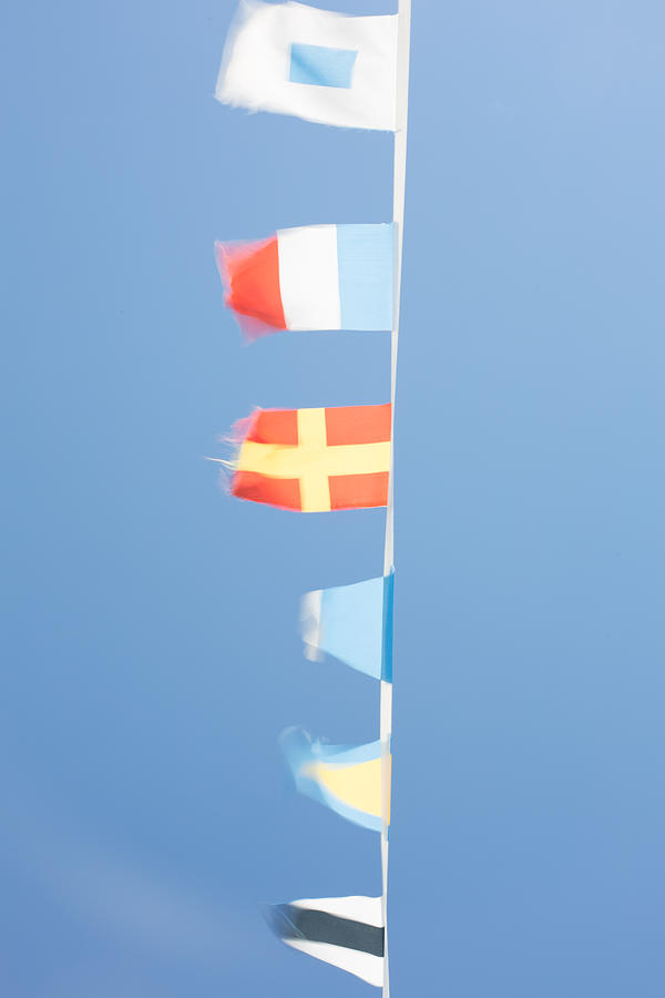 Nautical flags on a boat fluttering, Cannes, France Photograph by Alisonteale24