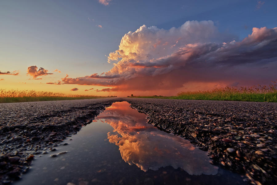 ND Showing off #3 - summer storm reflected on abandoned highway puddle near Churchs Ferry Photograph by Peter Herman