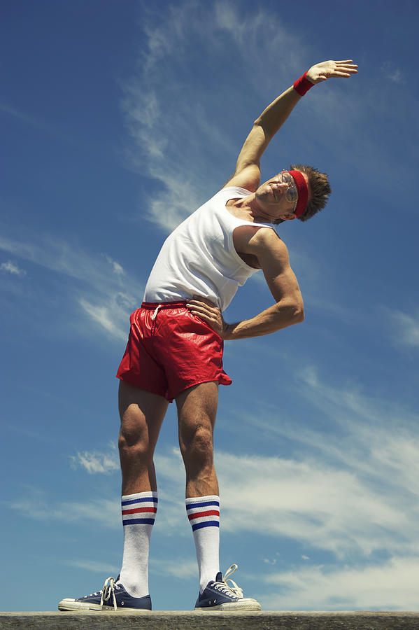 Nerd Athlete Stands Stretching Against Blue Sky Photograph by PeskyMonkey
