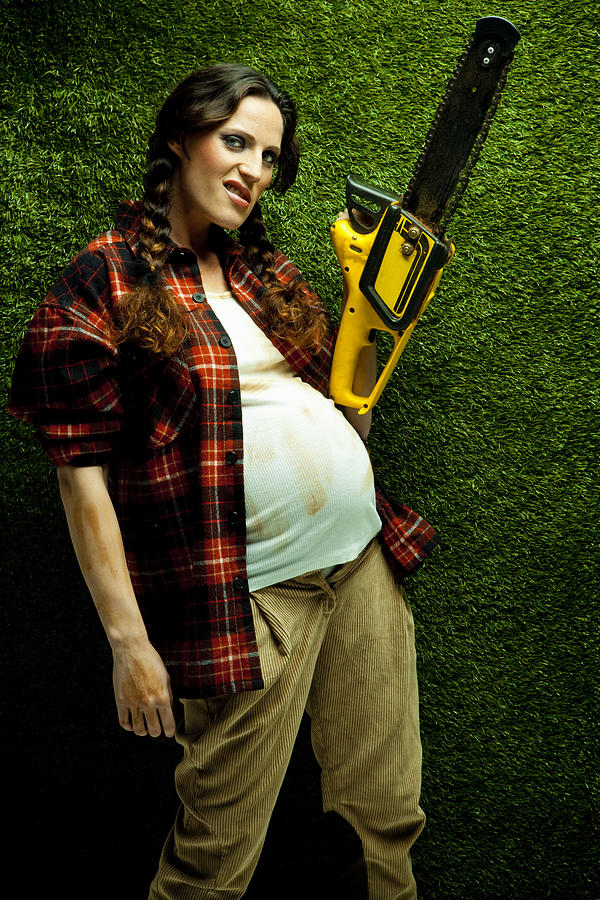 Nerd pregnant lumberjack holding a chainsaw Photograph by Caracterdesign