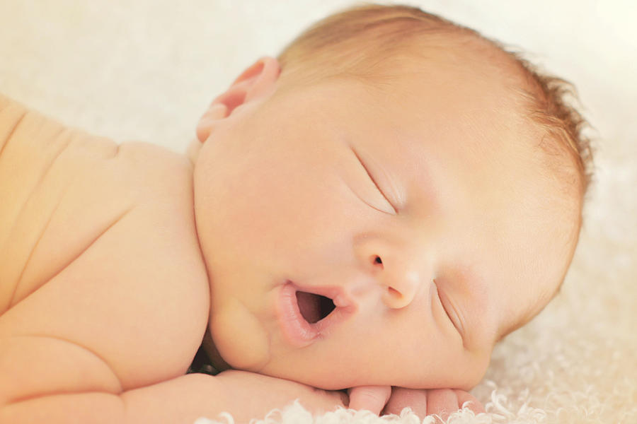 Newborn baby boy sleeping Photograph by Annette Bunch