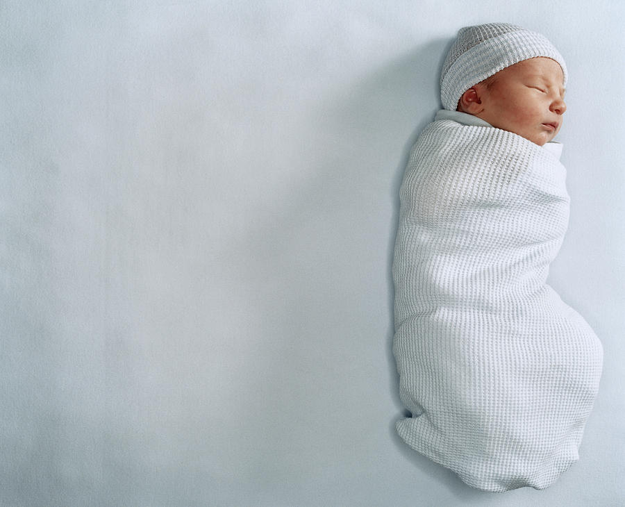 Newborn baby boy wrapped in blanket Photograph by Catherine Ledner