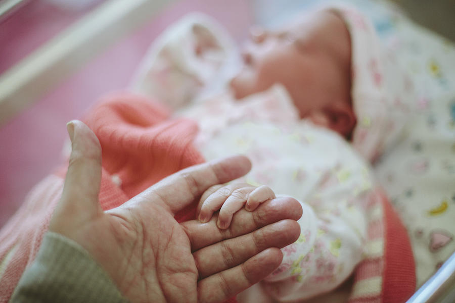 Newborn baby holding Mothers hand Photograph by Sally Anscombe