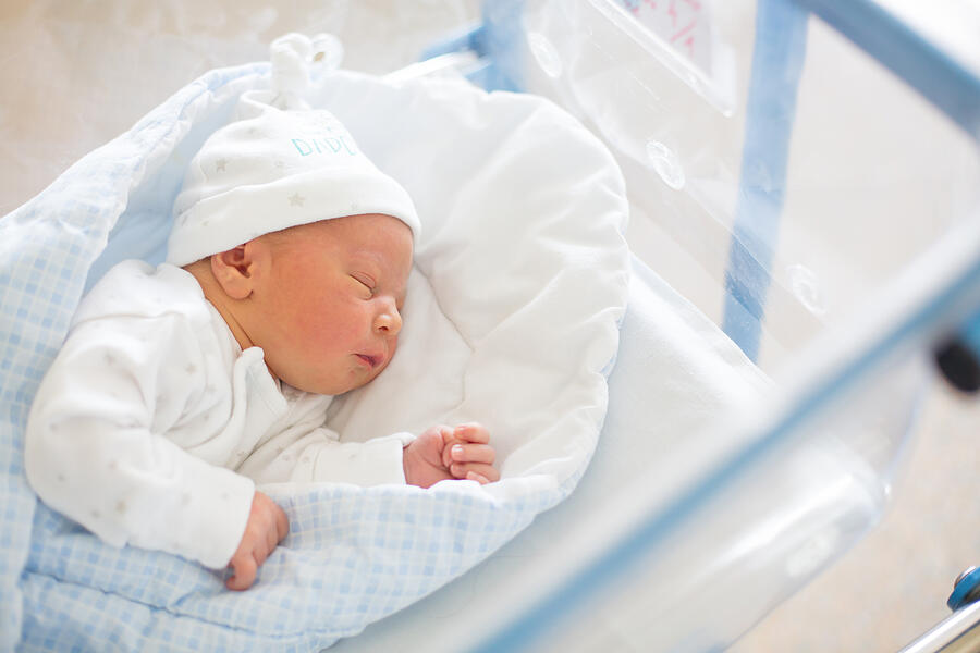 Newborn baby laying in crib in prenatal hospital Photograph by Tatyana_tomsickova