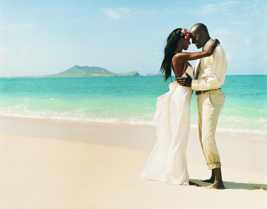 Newlywed Couple Dance Face-to-Face at the Waters Edge on a Beach Photograph by Digital Vision.