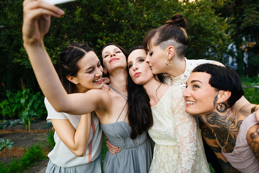 Newlywed lesbian couple with friends doing selfie Photograph by Hinterhaus Productions