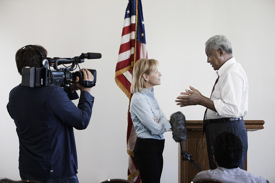 News reporter interviewing politician on camera Photograph by Hill Street Studios