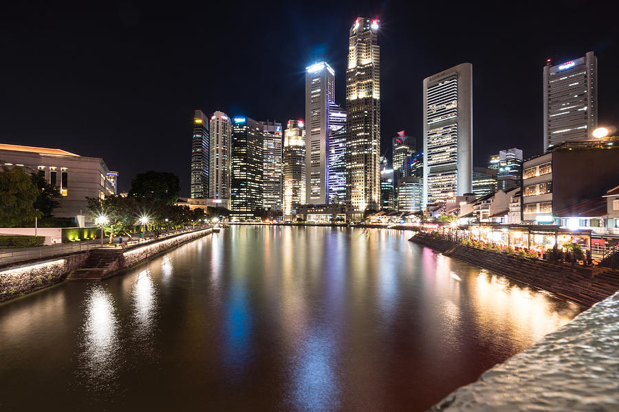 Night view of the Singapore river along Clark Quay in Singapore downtown district Photograph by @ Didier Marti