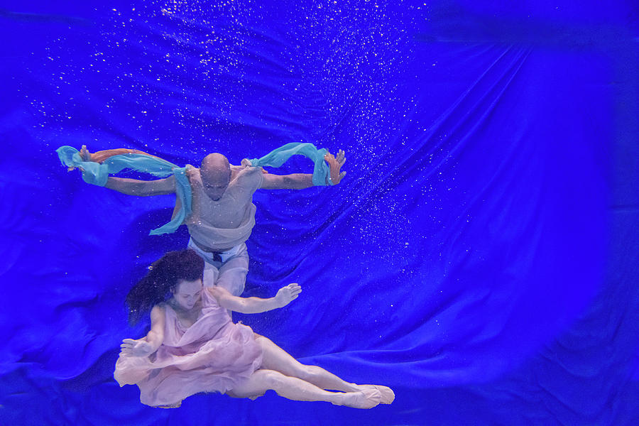 Nina and General dancing underwater in front of blue background 11 Photograph by Dan Friend