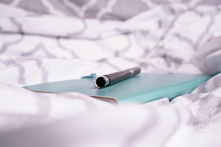 Notepad and pen on bed with modern bright bed sheets Photograph by Mendelex Photography