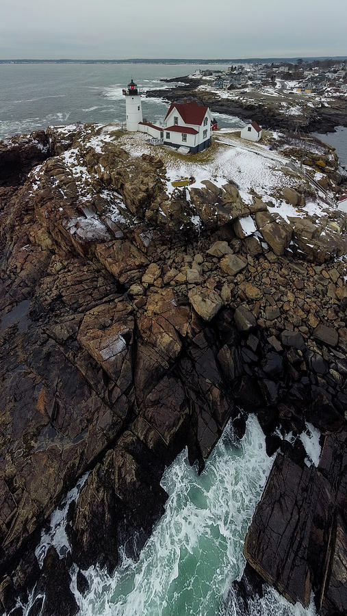 Nubble Light on the rocky coast of Maine Photograph by Jeff Folger